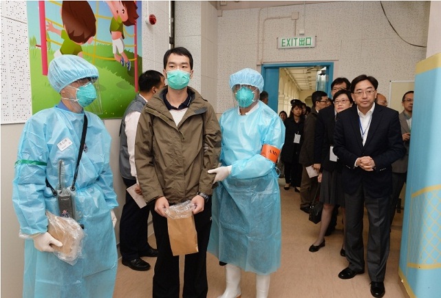 Dr Ko (first right) inspects the Medical Post where quarantine confinees' health assessment is conducted.