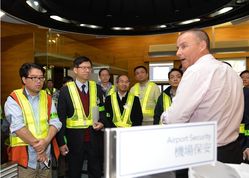 The Controller of the Centre for Health Protection of the Department of Health (DH), Dr Leung Ting-hung (second left) listens to a briefing during his inspection to the interdepartmental Exercise TOPAZ on Ebola virus disease in Hong Kong International Airport.