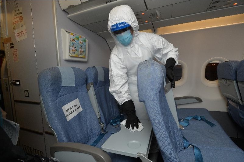 A cleansing contractor in PPE disinfects the airplane. A cleansing contractor in PPE disinfects the airplane.