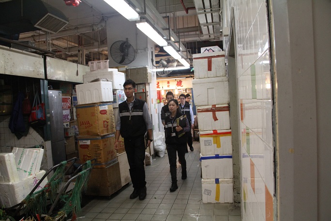 Tobacco Control Inspectors conduct an inspection at a market.